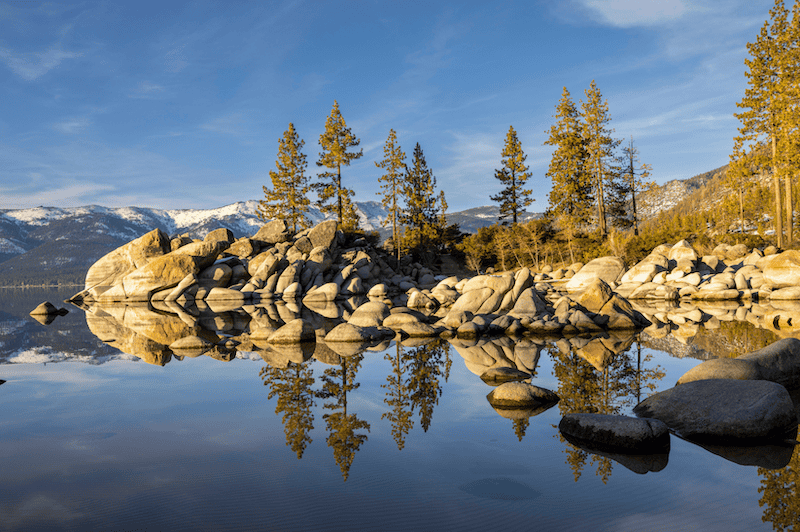 lake tahoe in fall with trees and blue skies